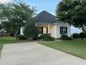 This home features a well-maintained lawn, a paved driveway, and mature landscaping that adds to its curb appeal at 526 Cardena School Rd, Fuquay Varina, NC 27526