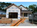 New home under construction with building wrap and materials on site; ready for customization at 701 East St, Smithfield, NC 27577