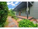 A charming home with a cozy front porch and a stone path surrounded by lush greenery at 701 Holloway St, Durham, NC 27701