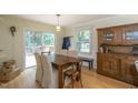 The dining area features a wooden table, cushioned chairs, wood floors, and a sliding glass door at 711 W Carver St, Durham, NC 27704