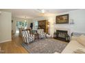 Cozy living room with a fireplace, a ceiling fan, a patterned rug, and a dining area at 711 W Carver St, Durham, NC 27704