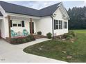 Charming single-story home with cozy front porch, outdoor seating, and well-manicured lawn at 8 Open View Ln, Timberlake, NC 27583