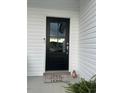 A black front door with a glass pane and a 'Home Sweet Home' welcome mat at 8 Open View Ln, Timberlake, NC 27583