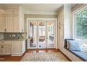 Elegant kitchen with white cabinetry, breakfast nook, and access to the sunroom at 1213 Pierce St, Raleigh, NC 27605