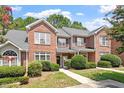 Inviting brick townhome with well-maintained landscaping and a welcoming entrance at 1505 Poets Glade Dr, Apex, NC 27523