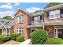Attractive brick townhome exterior with lush landscaping and inviting curb appeal at 1505 Poets Glade Dr, Apex, NC 27523
