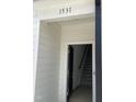 Townhome entryway showcasing a dark front door, light-colored interior, and stairs leading to the upper level at 1531 Crescent Townes Way, Raleigh, NC 27604