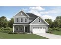Charming two-story home with gray siding, a covered porch, and an attached two-car garage at 1732 Goldfinch Perch Ln, Knightdale, NC 27545