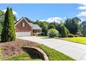 Well-maintained brick home with a spacious driveway and beautifully landscaped yard at 175 Georgetown Woods Dr, Youngsville, NC 27596