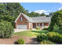 Inviting brick home with a two-car garage, lovely front yard, and mature landscaping at 175 Georgetown Woods Dr, Youngsville, NC 27596