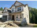 Exterior elevation of an unfinished two-story home with a covered porch, awaiting finishing touches at 177 Millwood Dr, Clayton, NC 27527