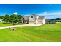 Spacious home with a large, manicured lawn, attached garage, and welcoming front porch at 20 Kola Nut, Smithfield, NC 27577