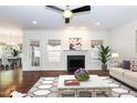 Bright living room with fireplace, windows, ceiling fan, and center table creating a cozy atmosphere at 212 Mickleson Ridge Dr, Raleigh, NC 27603