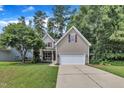 Charming two-story home featuring a well-manicured lawn and a two-car garage at 213 N Weststone Blvd, Fuquay Varina, NC 27526