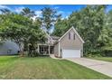 Charming two-story home featuring a well-manicured lawn and a two-car garage at 213 N Weststone Blvd, Fuquay Varina, NC 27526