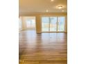 Inviting living area with sliding glass doors providing ample natural light and seamless access to the backyard at 2432 Nassau Trce, Fuquay Varina, NC 27526