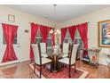 Stylish dining room featuring a glass table, seating for six, and hardwood floors at 2810 Catamaunt, Durham, NC 27704