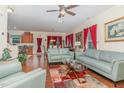 Spacious living room area with hardwood floors, modern furnishings and bright red curtains at 2810 Catamaunt, Durham, NC 27704