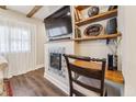 Living room featuring built-in shelves, decorative fireplace, and adjacent work space with dark wood flooring at 309 E End Ave, Durham, NC 27703