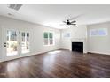 Open-concept living room featuring hardwood floors, a fireplace and french doors leading to the outdoors at 315 Sugarpine Trl, Clayton, NC 27520