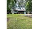 Single-story home with a spacious front yard and long driveway at 424 Shawnee Dr, Louisburg, NC 27549