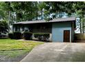Single story home with green siding and concrete driveway at 424 Shawnee Dr, Louisburg, NC 27549