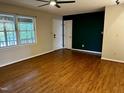 Spacious living room with hardwood floors, fan, and large windows at 424 Shawnee Dr, Louisburg, NC 27549