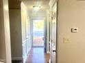 Inviting hallway with light walls, white trim, and a view to the front door at 4418 Roller Ct, Raleigh, NC 27604
