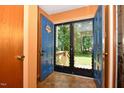 Inviting foyer featuring double doors, a screened door and a tile floor at 6308 Rolling Acres Drive, Gibsonville, NC 27249