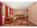Cozy living room with large sectional couch, colorful rug and natural light at 6308 Rolling Acres Drive, Gibsonville, NC 27249
