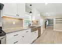 Updated kitchen features stainless steel appliances, granite countertops and a farmhouse sink at 7722 Nc 27, Lillington, NC 27546