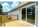 Outdoor deck with sliding glass doors, wooden railing, and plenty of space for entertaining at 101 Cottonwood Ct, Kenly, NC 27542