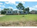 Bright and sunny home featuring a well maintained lawn, and light gray exterior at 103 Cottonwood Ct, Kenly, NC 27542