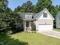 Beautiful exterior view of a two-story home featuring a well-maintained lawn and attached garage at 106 Dodge Ln, Smithfield, NC 27577