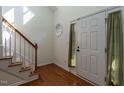 Bright foyer with hardwood floors, staircase, and a front door with natural light and hardwood flooring at 106 Dodge Ln, Smithfield, NC 27577