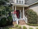 Inviting front porch with brick steps and decorative hanging flowers creating a welcoming entrance at 106 Dodge Ln, Smithfield, NC 27577