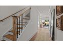 Bright foyer with wood stairs, neutral walls, and hardwood flooring leading into an open-concept living space at 134 Favored Avenue, Sanford, NC 27330