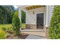 Inviting front porch featuring brick accents, crisp white siding, and manicured landscaping at 134 Favored Avenue, Sanford, NC 27330