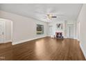 Bright living room featuring hardwood floors, a decorative fireplace, and large windows at 201 N Us 301, Micro, NC 27555