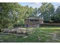 Spacious fenced in backyard featuring a brick home and beautiful landscaping at 3863 Avents Ferry Rd, Sanford, NC 27330