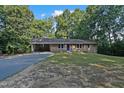 Beautiful brick home with a blue front door, covered carport, and well-maintained lawn at 3863 Avents Ferry Rd, Sanford, NC 27330