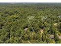 Aerial view of wooded acreage including 4134 KC Rd (0.73 ac.) and 4130 KC Rd (0.58 ac.) at 4134 King Charles Rd, Durham, NC 27707