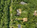 Aerial view of wooded acreage including 4134 KC Rd (0.73 ac.) and 4130 KC Rd (0.58 ac.) at 4134 King Charles Rd, Durham, NC 27707