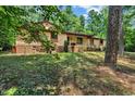 Inviting single-story home with a charming screened porch, nestled in a serene, wooded landscape at 4134 King Charles Rd, Durham, NC 27707