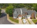 Birds-eye view of townhomes featuring mature trees, well-maintained landscaping, and individual driveways at 428 Grand Pointe Dr, Garner, NC 27529
