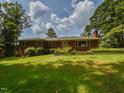 A charming single-story brick home with a well-manicured lawn and decorative planters at 4324 Garland Dr, Raleigh, NC 27606