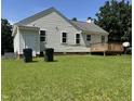 Backyard features a deck, well-maintained lawn, and white siding, complemented by a brick foundation at 6 Boxley Dr, Wendell, NC 27591