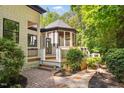 Charming screened-in gazebo with wood deck and stone pathway, perfect for relaxing at 6701 Green Hollow Ct, Wake Forest, NC 27587