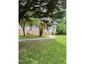 Charming single-story home featuring a covered porch, brick foundation and well-maintained lawn at 9160 Old Cascade Road Dr, Garner, NC 27529