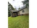 View of the home's rear screened in porch and an adjacent yard at 9160 Old Cascade Road Dr, Garner, NC 27529